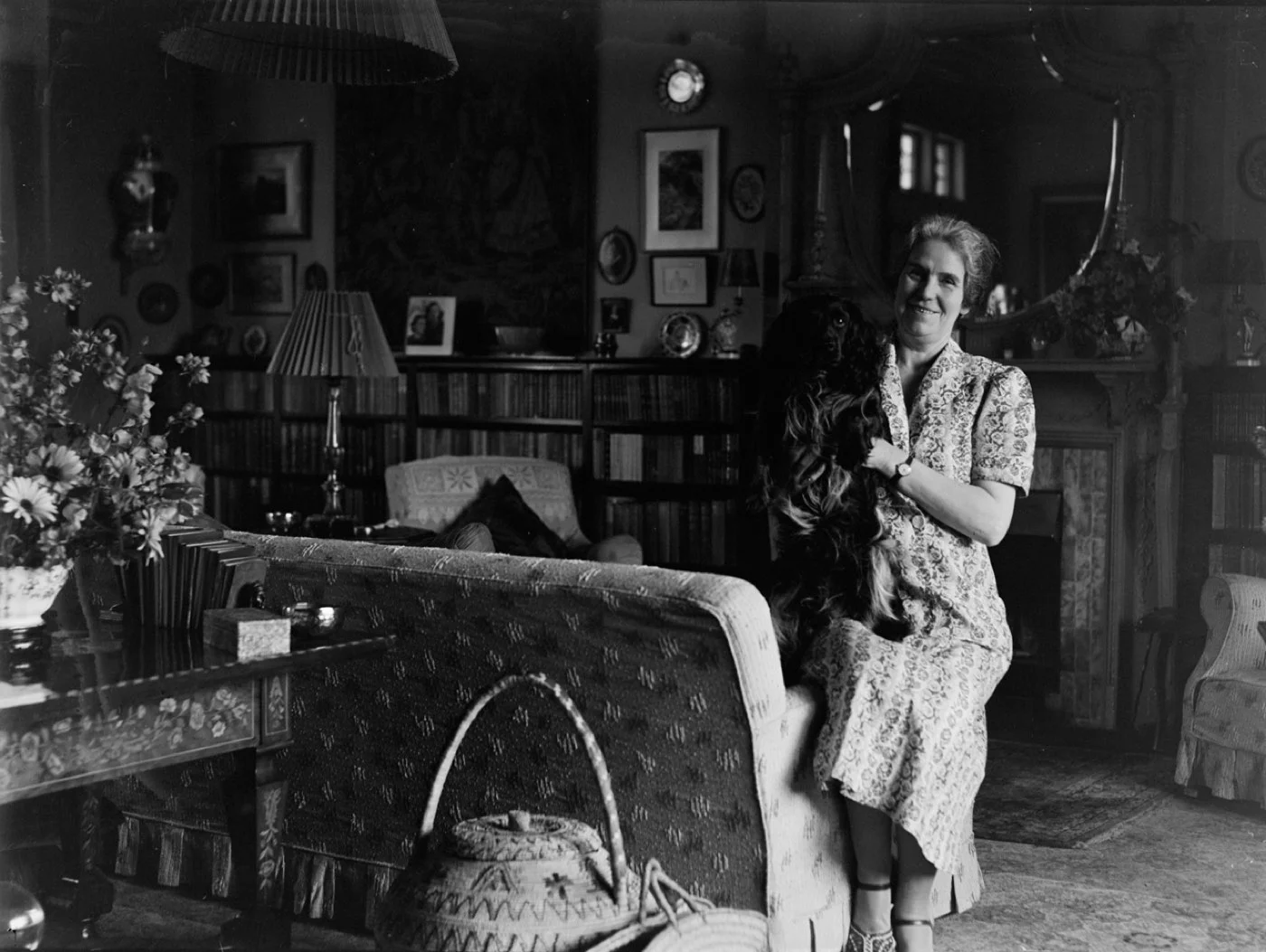A woman reading on a tablet on her couch in the evening